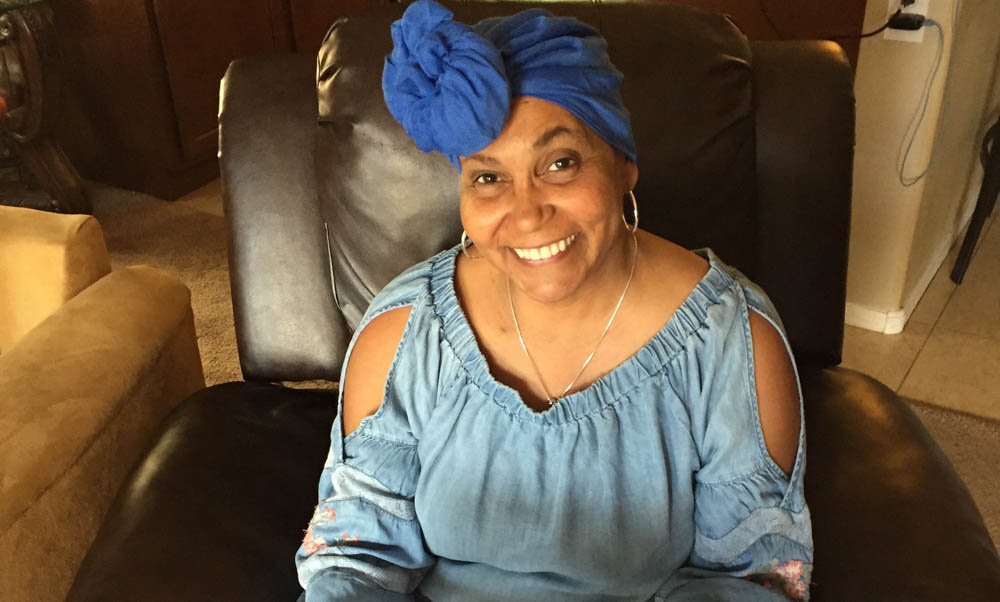 Joanne sitting down smiling