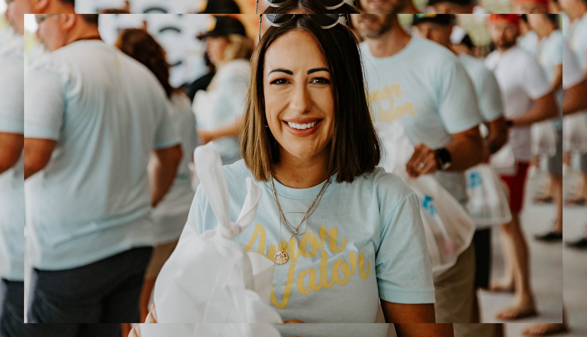Woman standing in front of crowd smiling