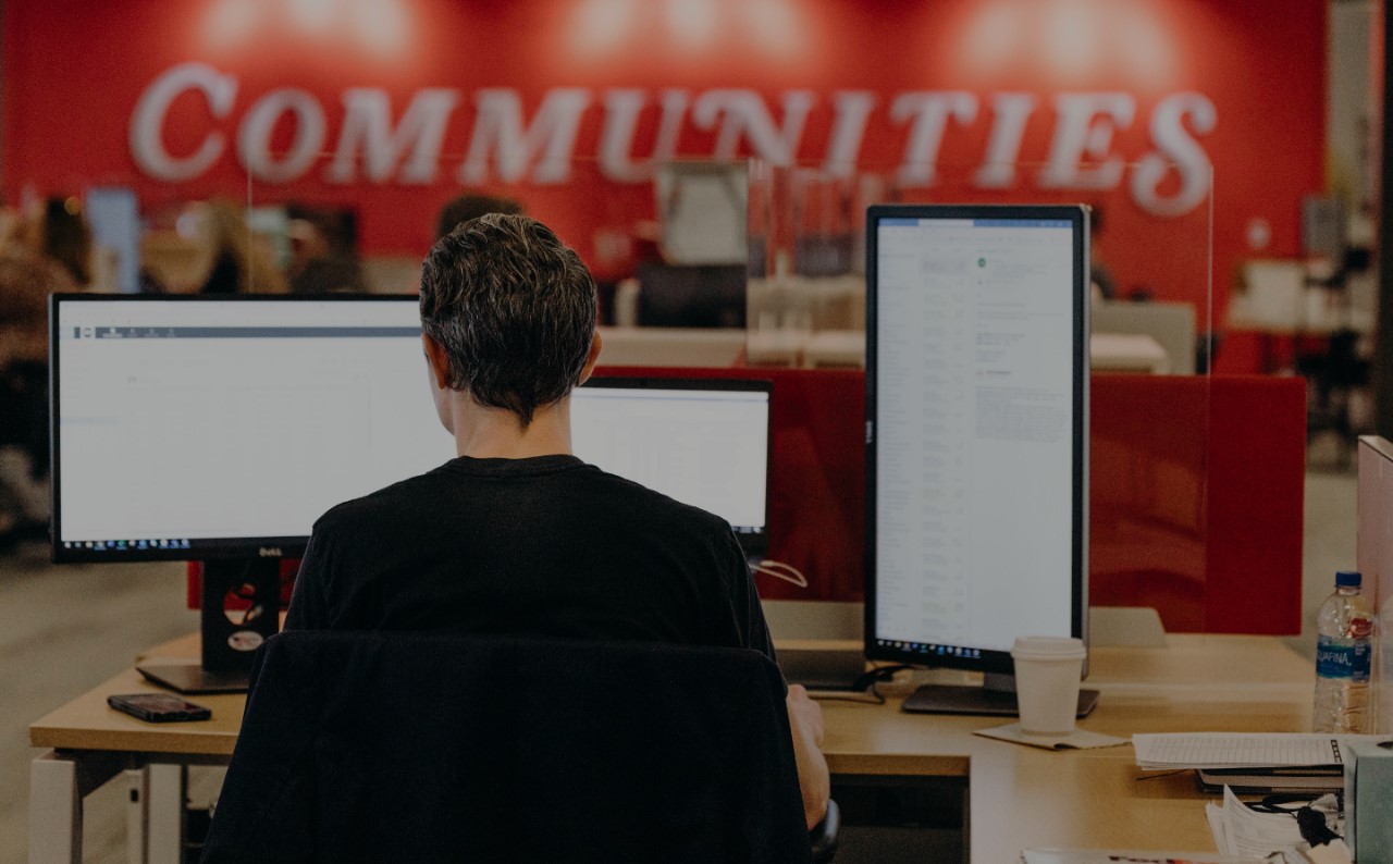 Man working on computer facing away from the camera